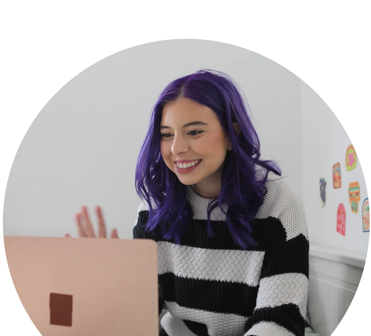 student attending to an online class wearing a stripped sweater